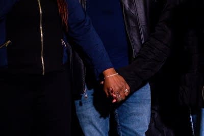 Members of Amir Locke's family hold each others' hands