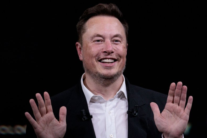 Elon Musk black backdrop hands up