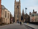Pedestrians walk through the University of Toronto campus in Toronto. 
