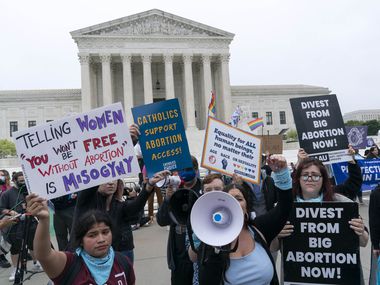 Demonstrators protest outside of the U.S. Supreme Court early Tuesday, May 3, 2022, after...