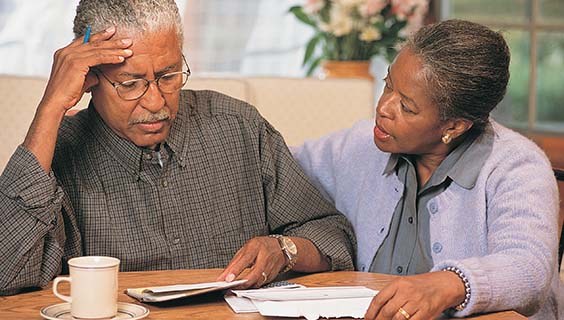 Older couple filling out legal and financial paperwork for people with Alzheimer's disease